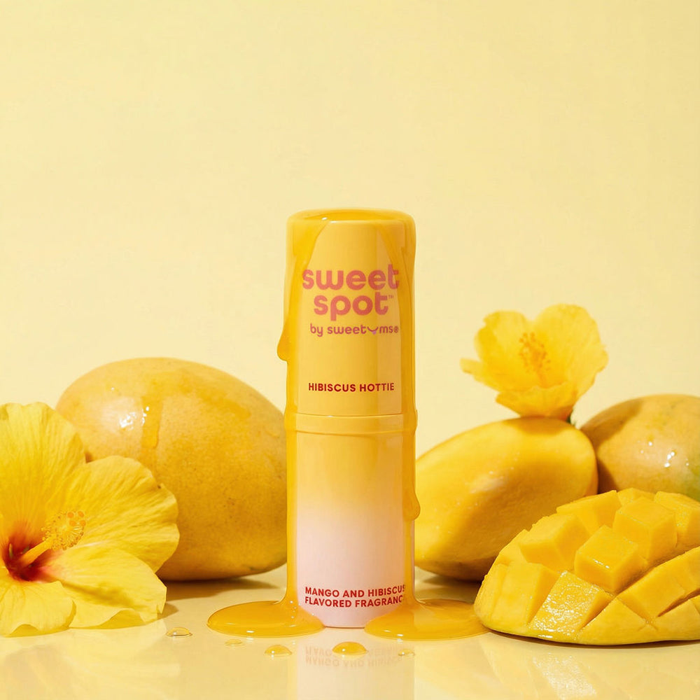 Sweetums Sweet Spot Flavored Fragrance Hibiscus Hottie with mango and hibiscus on a yellow background