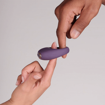 Je Joue Mio V2 Vibrating Cock Ring Black being held by two hands, showcasing its sleek design and intimacy-enhancing features.