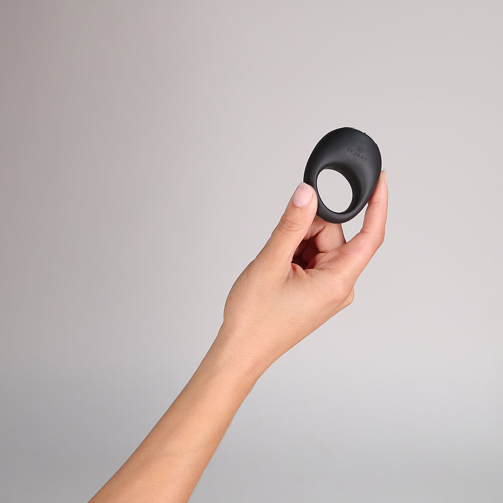 Je Joue Mio V2 Vibrating Cock Ring Black held in hand against a neutral background