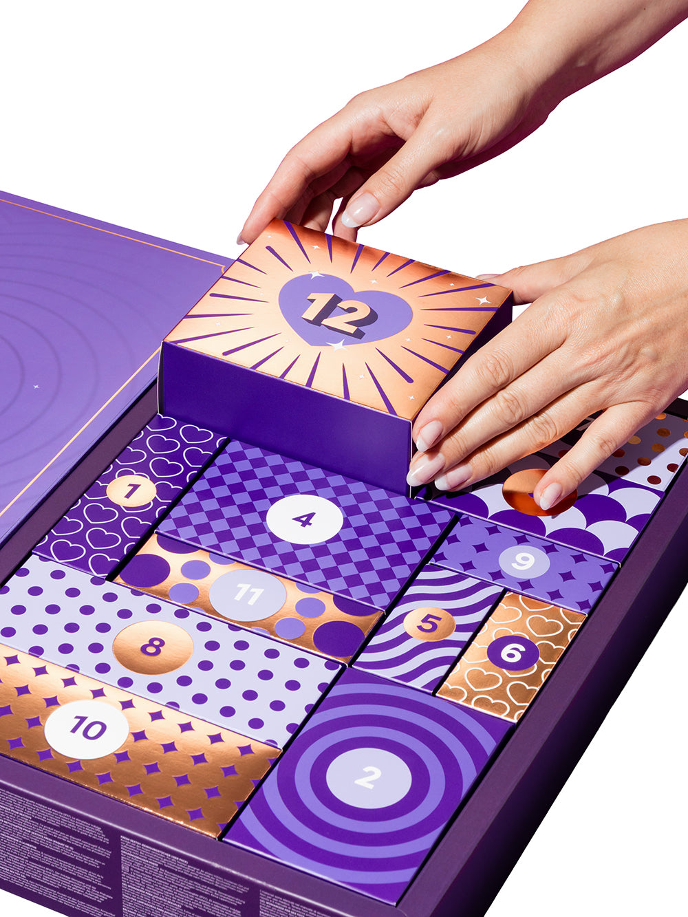 Lovehoney Indulge 12 Day Advent Calendar 2026 with hands opening the surprise box number 12.
