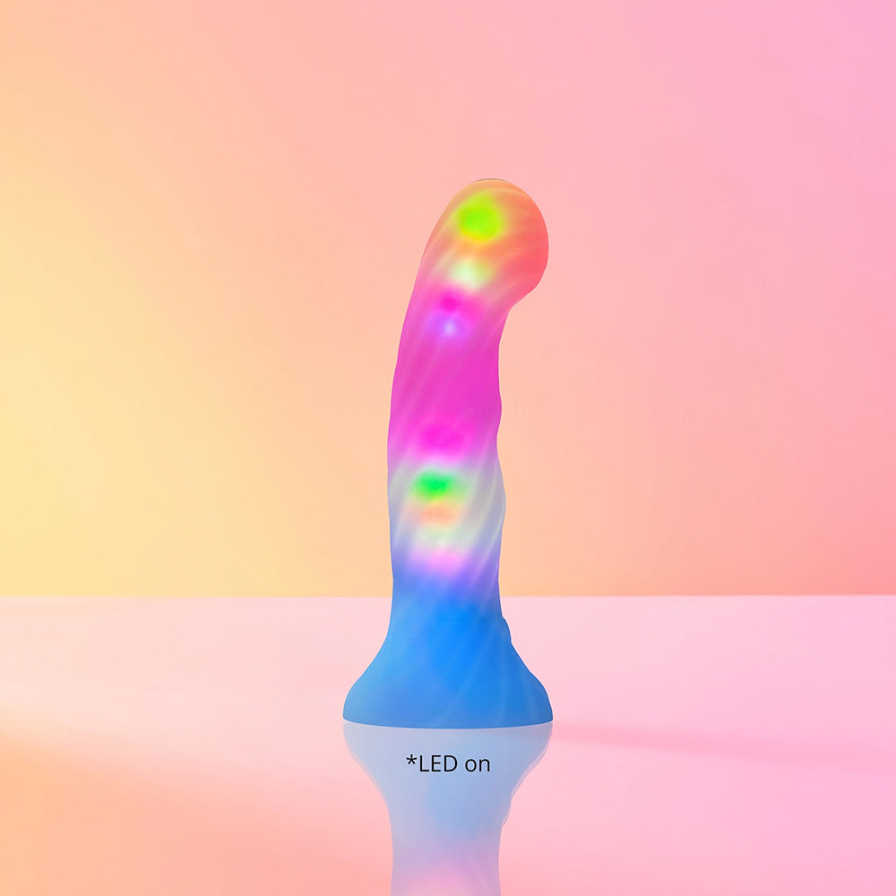 Love To Love Dildo Led Candy Loop with colorful LED lights and smooth design on a reflective surface.