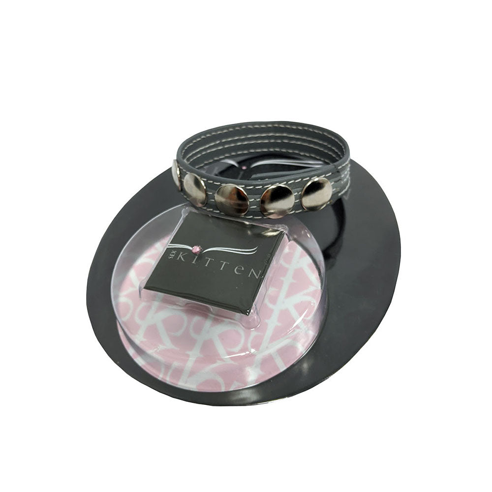 Sex Kitten Leather 5-Snap Cock Ring Black displayed on packaging, showcasing its stylish and adjustable design.