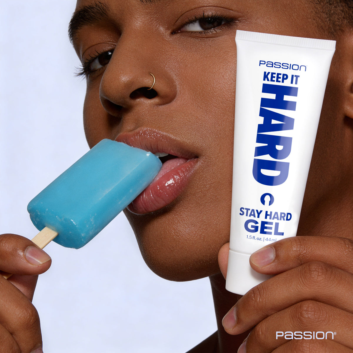 Passion Keep It Hard Stay Hard Gel 1.5 Oz shown with model holding blue popsicle.
