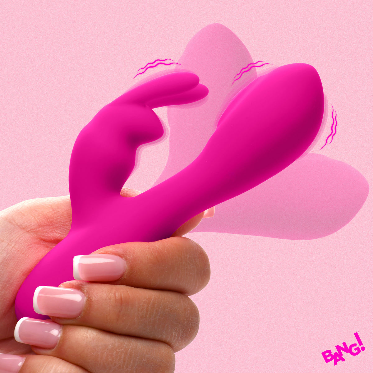 Hand holding Flexible Vibrating Silicone Mini Rabbit Pink on a pink background, showcasing its dual-motor design.