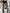 Leg Avenue Posy Tattered Footless Tights Black One Size displayed with a pleated black skirt and high-heeled boots.