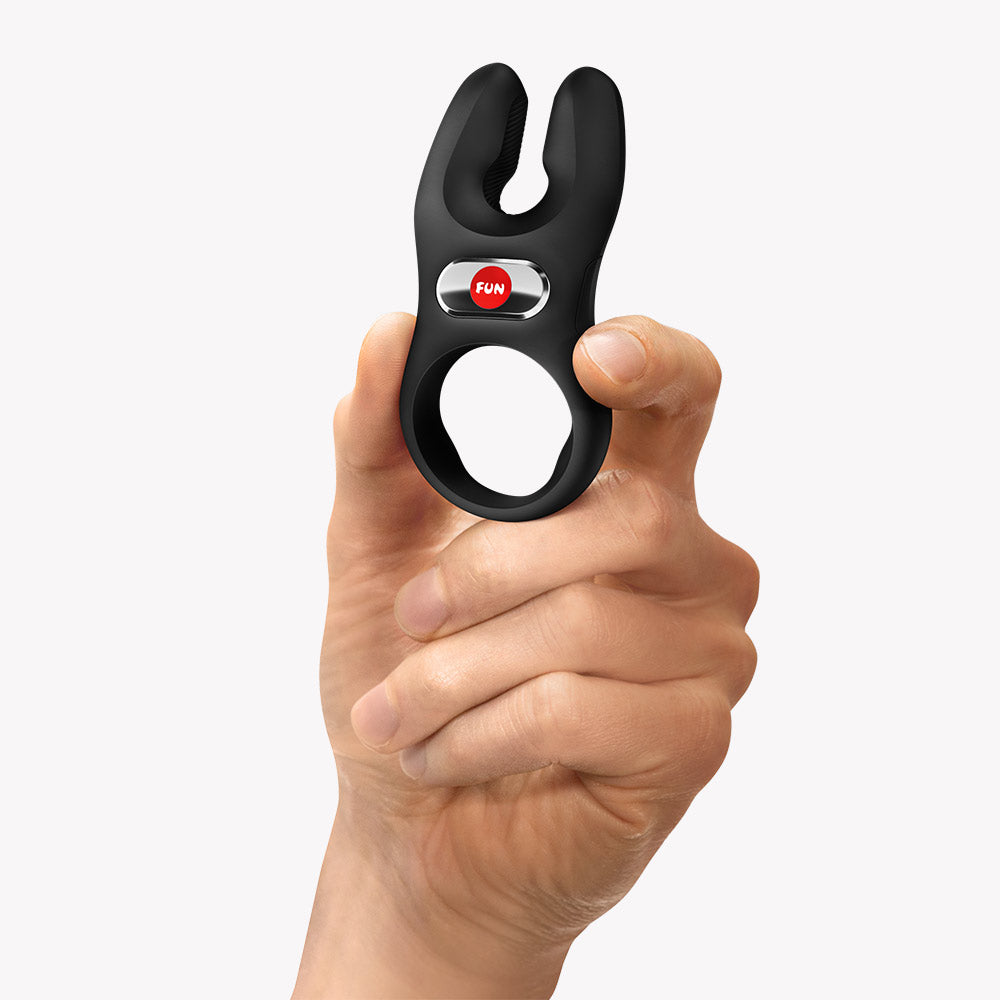 Fun Factory Nos Pro Vibrating Cock Ring Black held in a hand, showcasing its design and features.