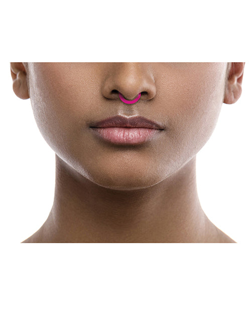 Rave Ring NRG Single Sachet Energy Scent Pink displayed on a model's nose, showcasing a vibrant pink aroma accessory.