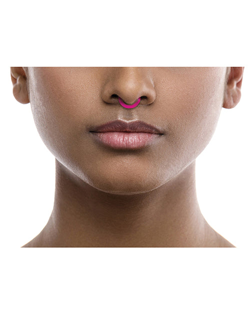 Rave Ring Vapor Single Sachet Eucalyptus Scent Pink worn on the septum of a person's nose, showcasing its vibrant design.