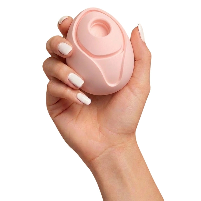 Bella Peach Rechargeable Clitoral Vibrator held in a hand, showcasing its playful fruit-inspired design and compact size.