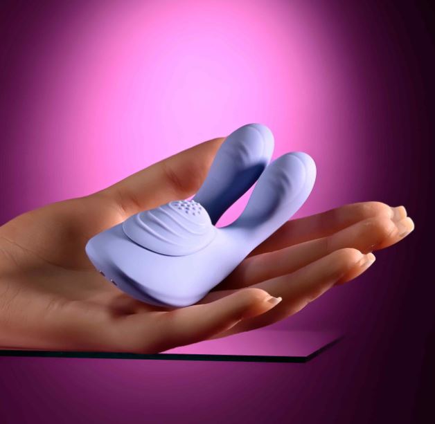 Selopa Handsy Rechargeable Silicone Palm Vibrator Blue on a hand, showcasing its ergonomic design and soft silicone texture.