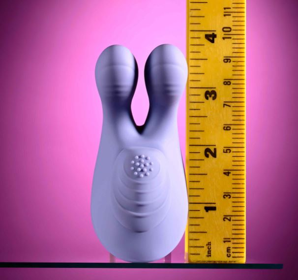 Selopa Handsy Rechargeable Silicone Palm Vibrator Blue next to a ruler for size comparison on a pink background.