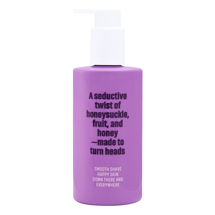 Coochy Shave Cream Flirty Blooms 8 Oz in a purple bottle with floral scent description for smooth shaving.