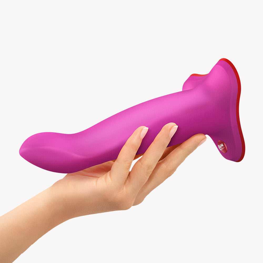 Fun Factory Limba Flex M Bendable Dildo Magenta held in a hand, showcasing its flexible design for targeted massage.