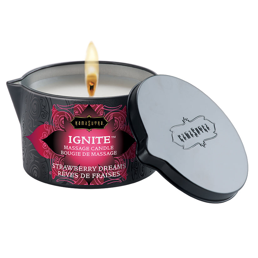 Kama Sutra Ignite Massage Candle Strawberry Dreams 6 Oz with lit wick and elegant packaging.