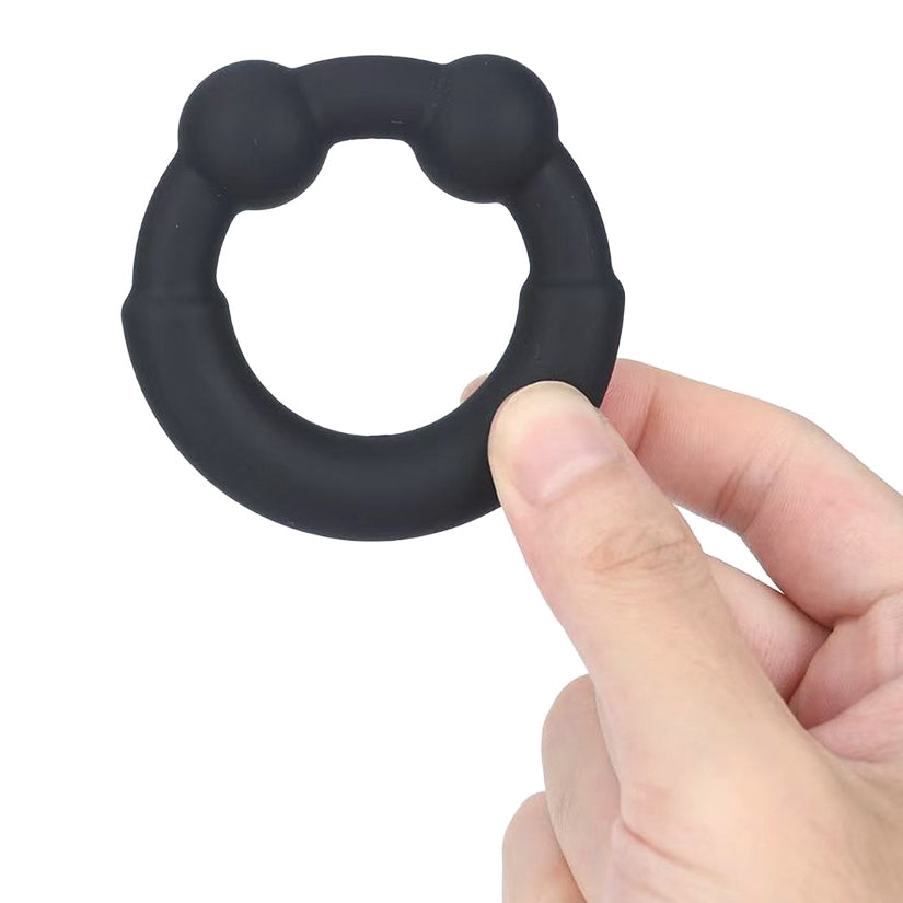 A man holding the Maia Toys Axel Cock Ring for Men, designed for enhanced confidence and pleasure.