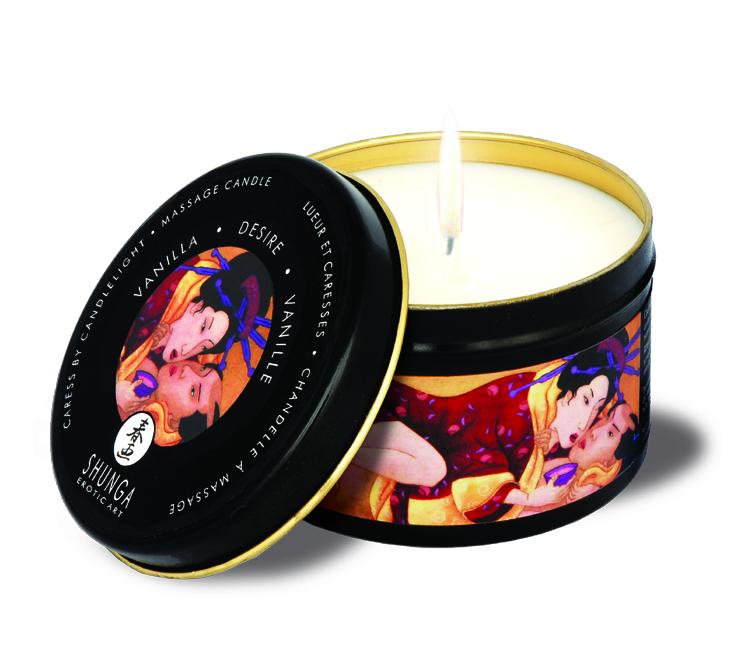 Shunga Massage Candle Desire Vanilla 5.7 Oz in black tin with gold lid, lit candle, and vibrant artwork.