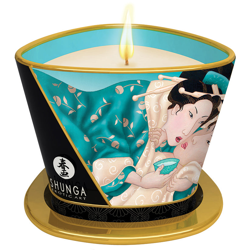 Shunga Massage Candle Island Blossoms 5.7 Oz with burning wick and artistic packaging design.