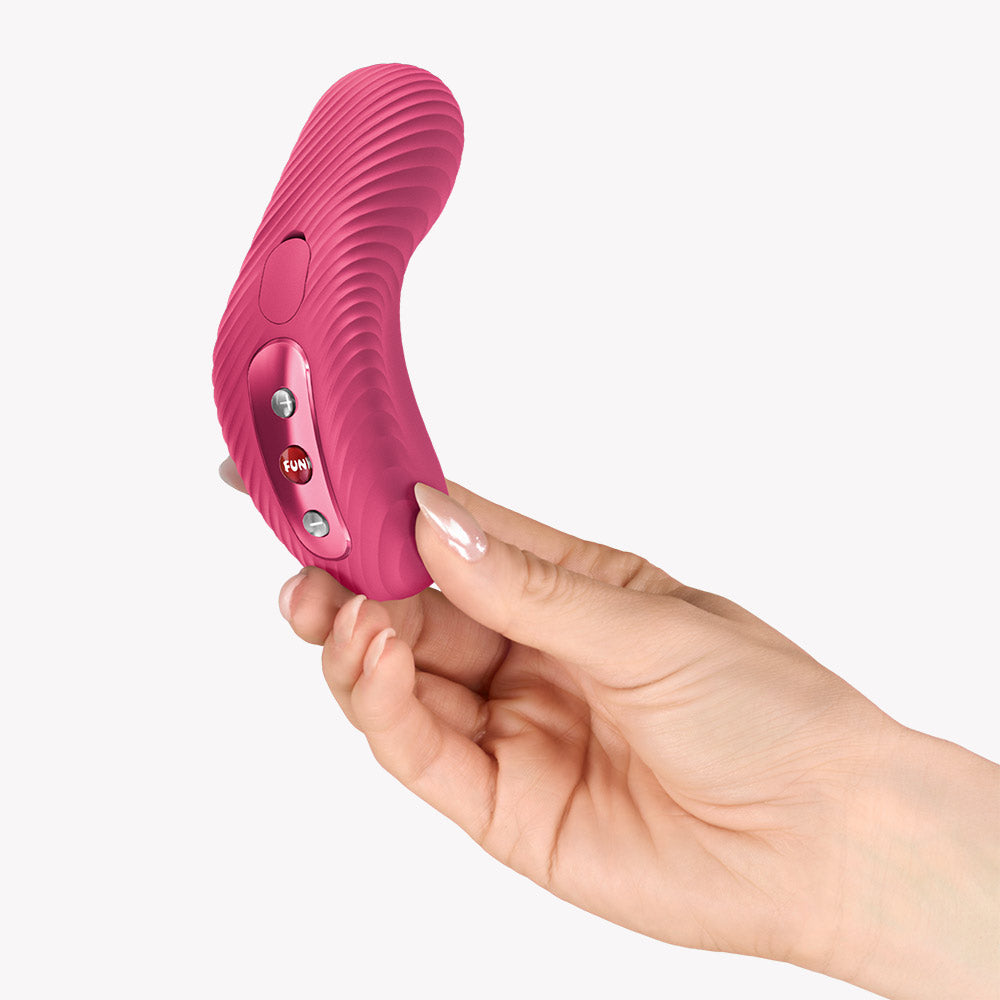 Fun Factory Laya III Lay-on Vibrator Magenta held in hand, showcasing its ergonomic design and control buttons.