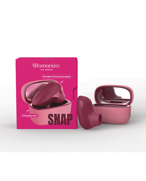 Womanizer Snap Clitoral Stimulator Crushed Berry with charging case in a compact design.