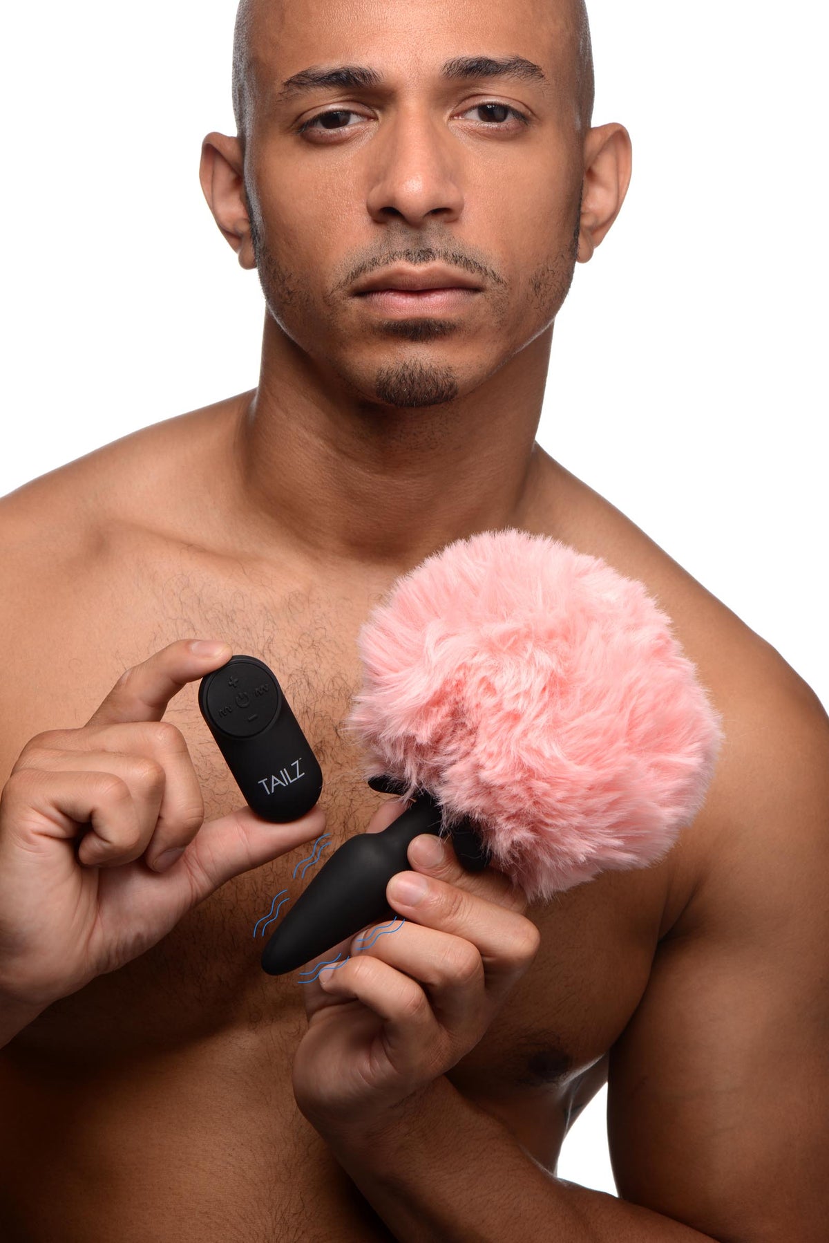 Vibrating Silicone Anal Plug with 3 Interchangeable Tails held by a model with remote control, showcasing playful design.