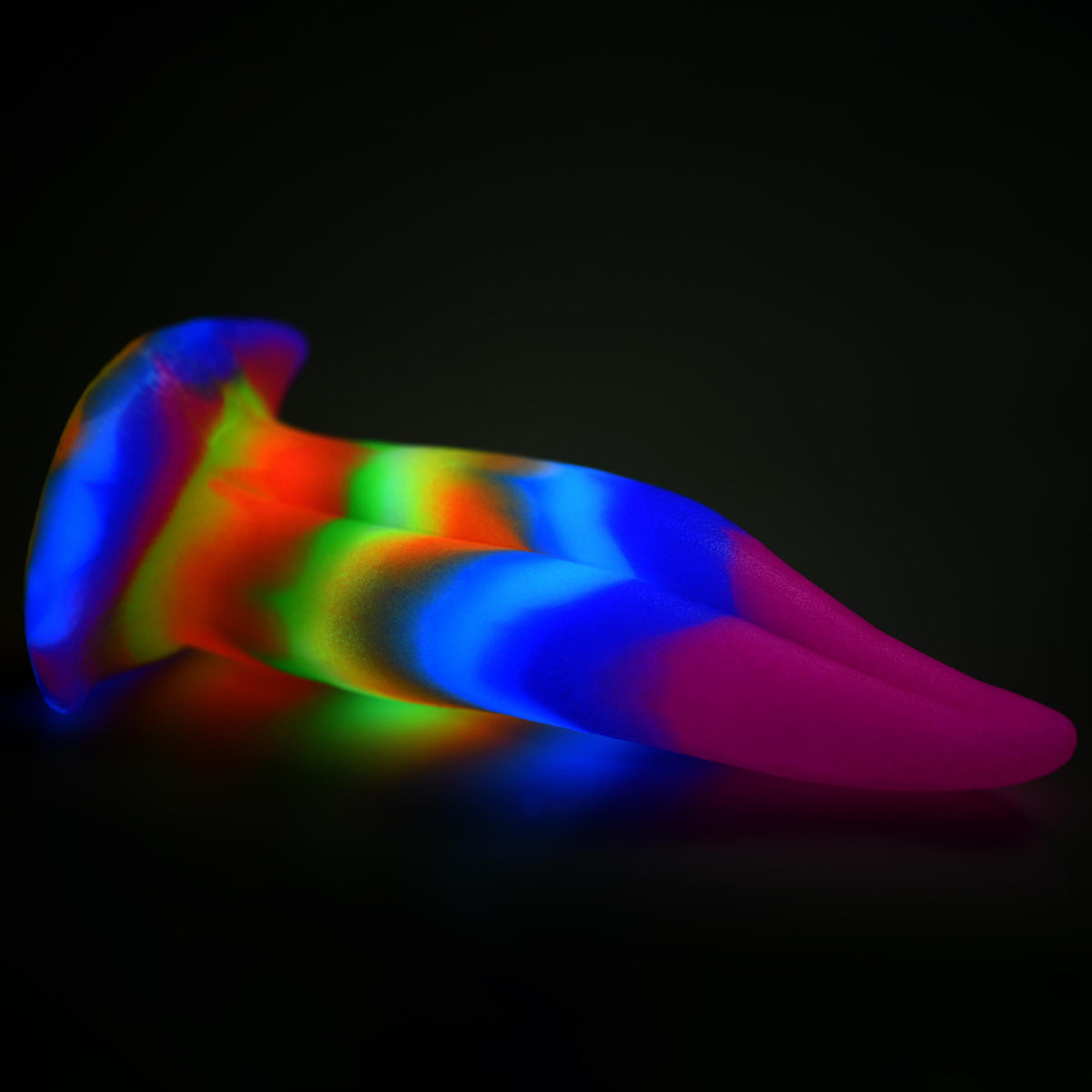 Unicorn Kiss Unicorn Tongue Glow-in-the-Dark Silicone Dildo with multi-colored design glowing in low light.