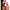 Unicorn Kiss Unicorn Tongue Glow-in-the-Dark Silicone Dildo held by a model, showcasing its vibrant colors.