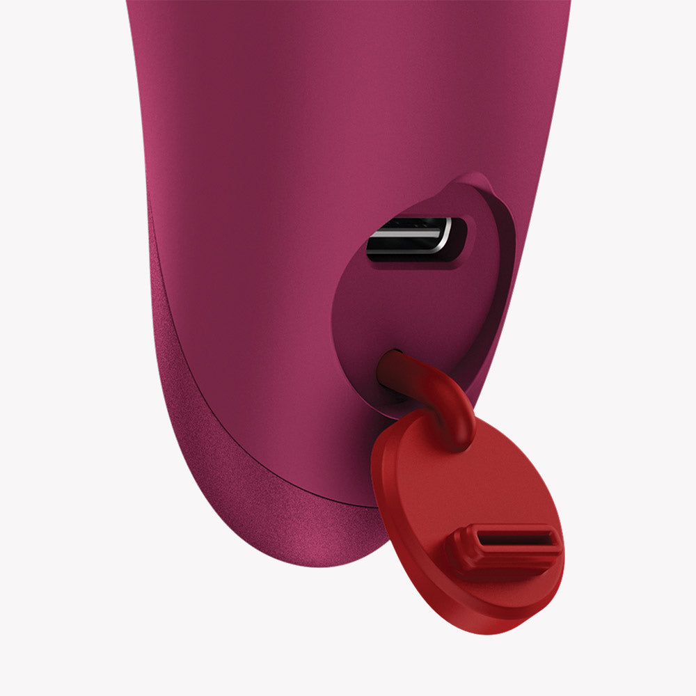 Close-up of Fun Factory Charme Bullet Vibrator Wine Red showing charging port with red cover.