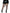 Leg Avenue Cracked Fishnet Tights 1X/2X Black worn with a black mini skirt and stylish heeled boots.