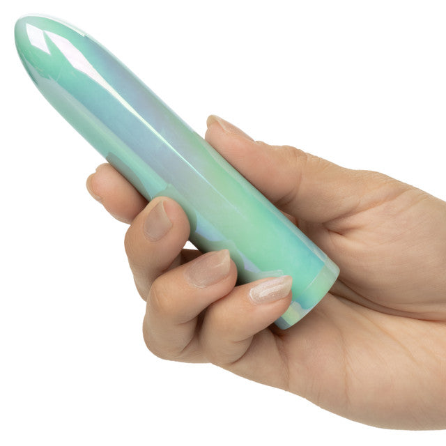 Aura Standard Rechargeable Silicone Stimulator Teal held in hand, showcasing its sleek and compact design.
